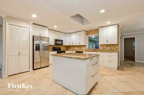Winter Park house for rent - a large kitchen with white cabinets and a stainless steel refrigerator