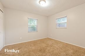Winter Park house for rent - a bedroom with a carpeted floor and two windows
