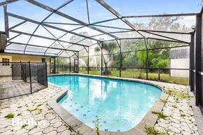 Winter Park house for rent - a swimming pool with an enclosure around it