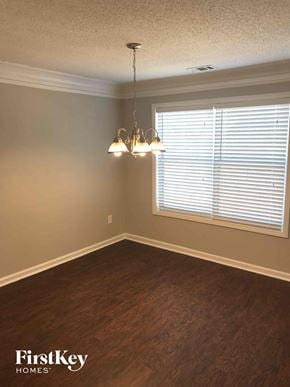 Lithonia house for rent - an empty dining room with a window and a chandelier