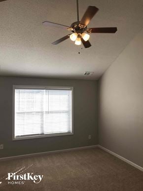 Lithonia house for rent - a bedroom with a ceiling fan and a window