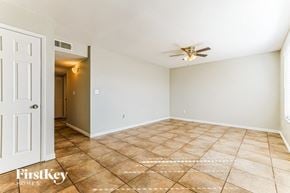 Peoria house for rent - a empty living room with a ceiling fan