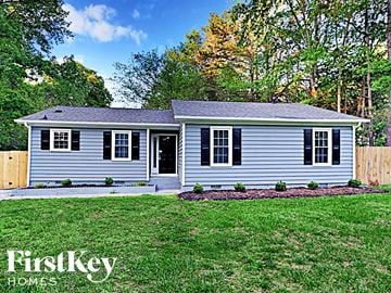Charlotte house for rent - a white house with a yard and a fence