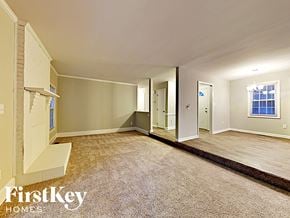 Charlotte house for rent - an empty living room with a wood floor and white walls