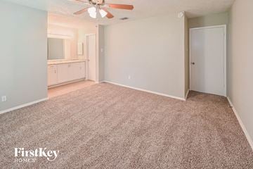 Richmond house for rent - a living room with carpet and a ceiling fan