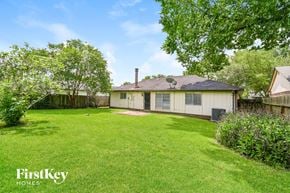 Richmond house for rent - a backyard with a white house and a grassy yard