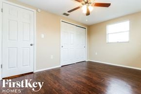Port Richey house for rent - a living room with wood flooring and a ceiling fan