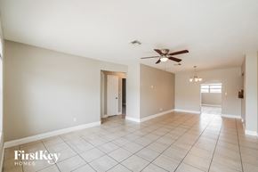 Hollywood house for rent - a spacious living room with tile flooring and a ceiling fan