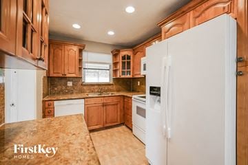 Hollywood house for rent - an updated kitchen with white appliances and wooden cabinets