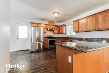 Phoenix house for rent - A kitchen with wooden cabinets and a granite countertop.
