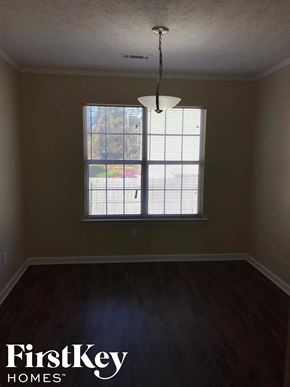 Riverdale house for rent - an empty living room with a large window
