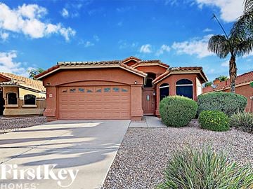 Mesa house for rent - a single story home with a garage and a driveway