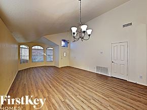 Mesa house for rent - an empty living room with wood floors and a white door