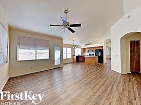 Mesa house for rent - an open living room and kitchen with wood floors and a ceiling fan
