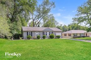 Kansas City house for rent - a home with a green lawn and some trees