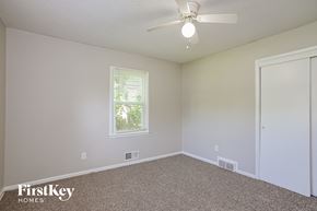 Kansas City house for rent - a bedroom with carpet and a ceiling fan