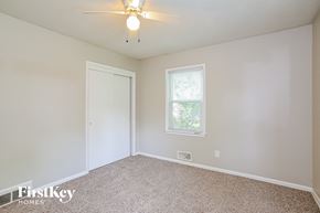 Kansas City house for rent - the living room of an empty home with a ceiling fan