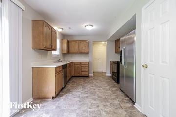 Indianapolis house for rent - A kitchen with wooden cabinets and a tiled floor.