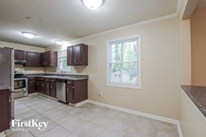 Charlotte house for rent - a kitchen with a sink and a stove and a window
