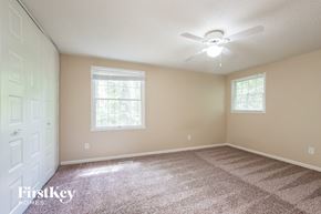 Charlotte house for rent - a bedroom with carpet and a ceiling fan