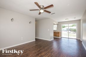 North Port house for rent - A room with a ceiling fan and wooden flooring.