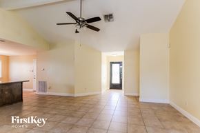 Houston house for rent - A spacious room with a ceiling fan and tiled floor.