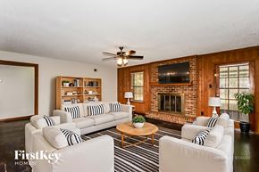 Memphis house for rent - A living room with a fireplace and a television.