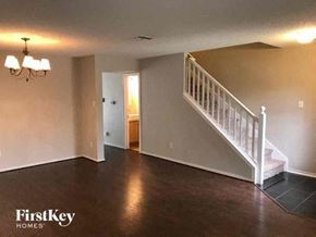 Arlington house for rent - A spacious room with a staircase leading to the second floor.