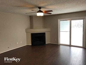 Arlington house for rent - A living room with a fireplace and a ceiling fan.