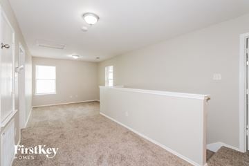 Cypress house for rent - a spacious living room with a white wall and carpet