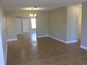 Hollywood house for rent - A room with tile flooring and a chandelier.