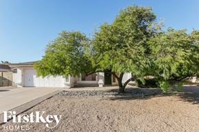 Peoria house for rent - A tree in front of a house with the words "FirstKey Homes" on the bottom.
