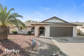 Glendale house for rent - A house with a palm tree in front and a sign that says "FirstKey Homes".