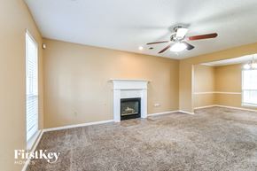 Walls house for rent - a living room with a fireplace and a ceiling fan