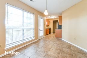 Walls house for rent - an empty living room with a large window and a kitchen