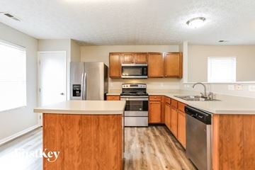 Canal Winchester house for rent - A kitchen with wooden cabinets and stainless steel appliances.