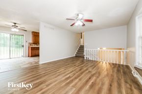 Raytown house for rent - a living room with wood flooring and a ceiling fan
