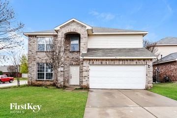 Fort Worth house for rent - the front of a brick house with a white garage door
