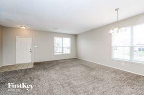 Fort Worth house for rent - a spacious living room with carpet and a white door