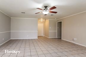 Humble house for rent - a living room with a ceiling fan and a tiled floor