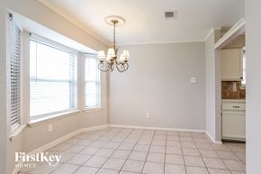Humble house for rent - a dining room with a chandelier and a window