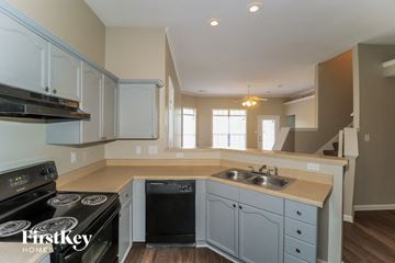 Cordova house for rent - A kitchen with a stove top oven and a dishwasher.