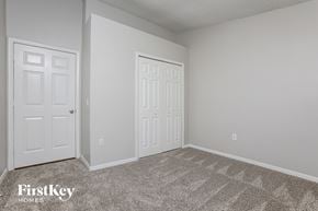 Orlando house for rent - a bedroom with two white doors and a carpeted floor