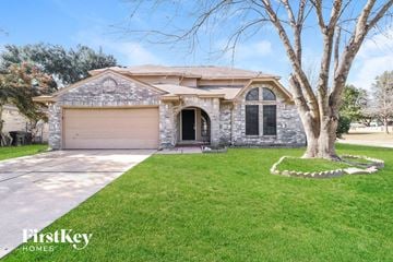 Houston house for rent - a stone house with a tree in front of it