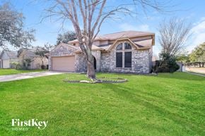 Houston house for rent - a stone house with a tree in the front yard