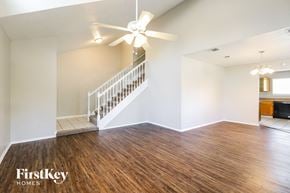 Houston house for rent - a living room with hardwood flooring and a ceiling fan