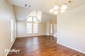 Houston house for rent - an empty living room with hardwood flooring and a window