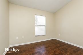 Orlando house for rent - a bedroom with wood flooring and a window