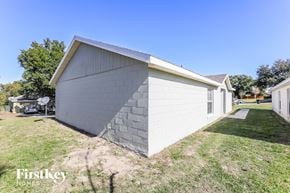Orlando house for rent - a small white building with a gray roof and a driveway