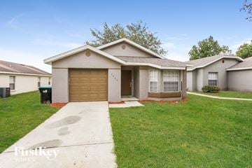 Orlando house for rent - a home with a driveway and a garage door